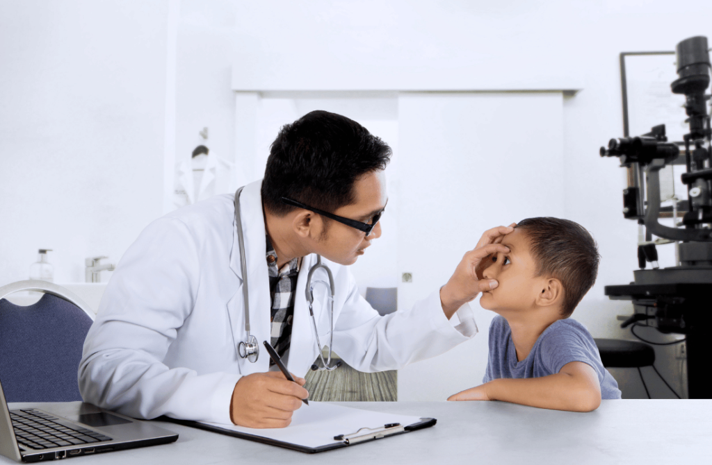 Doctor examining the eyes of a young boy to ensure healthy vision and early detection of pediatric eye conditions.