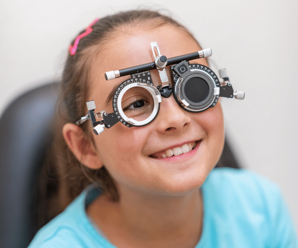 A girl undergoing an eye lens examination to evaluate refractive errors or other visual impairments